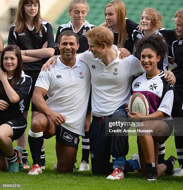 Prince Harry and English International Jason Robinson pose with girls taking part in the RFU All School Programme Coaching Event at Twickenham...