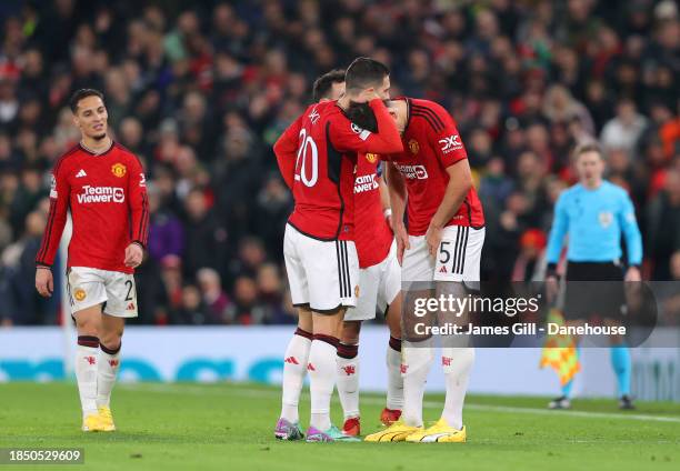 Harry Maguire of Manchester United is consoled by Diogo Dalot after getting injured and is substituted during the UEFA Champions League match between...