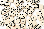 Scattered ivory domino pieces isolated on white background