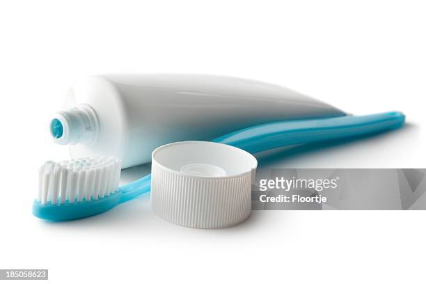 bath: toothbrush and toothpaste isolated on white background - toothpaste stock pictures, royalty-free photos & images