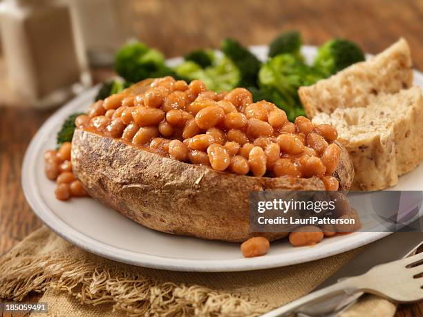 jacket potato with baked beans - baked potato stock pictures, royalty-free photos & images
