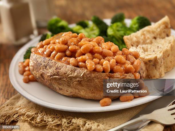 jacket potato with baked beans - baked sweet potato stock pictures, royalty-free photos & images