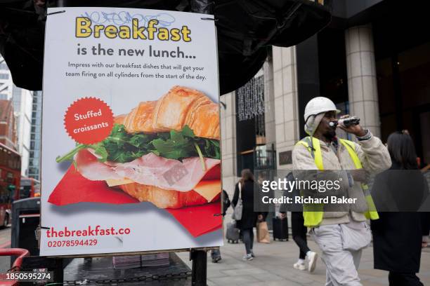 An advert for 'The Breakfast Co' proclaims that Breakfast is the new lunch for working Londoners, outside Liverpool Street Station in the City of...