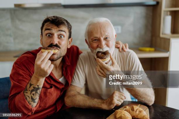 father son spending time together - donut man stock pictures, royalty-free photos & images