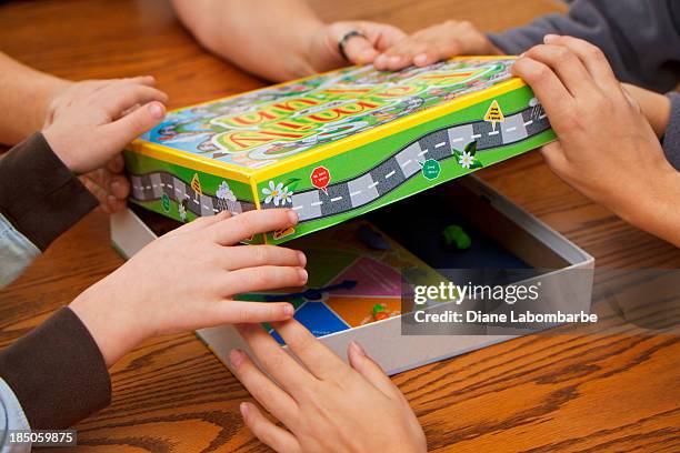 family choosing board games to play - bordspel stockfoto's en -beelden