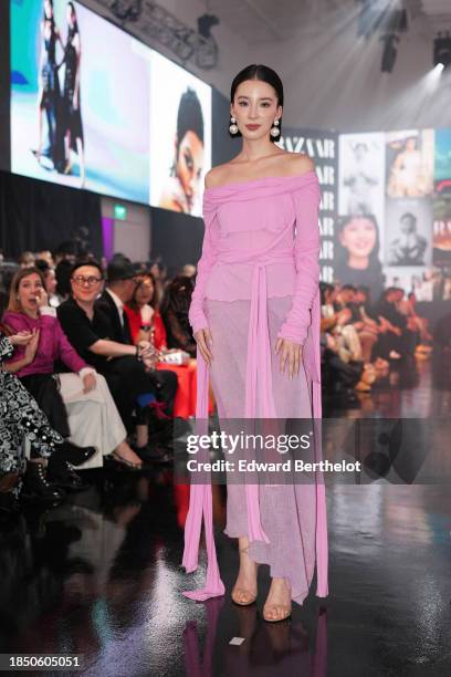 Irene Kim wears pearl earrings, a pink gathered off shoulder dress with mesh parts and long sleeves, during the Harper’s BAZAAR NewGen Award 2023, on...