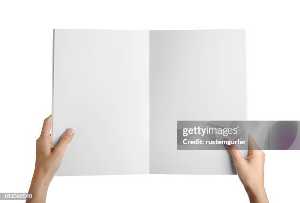 hands holding blank magazine page - elevated view of person on white background stock pictures, royalty-free photos & images