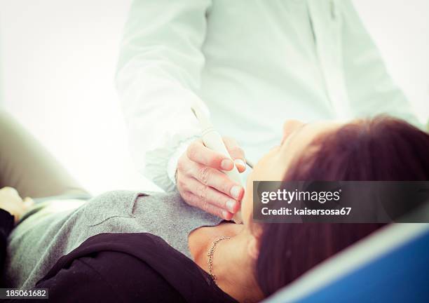 scanning of a thyroid - thyroid exam stock pictures, royalty-free photos & images