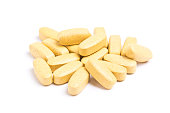 Yellow vitamin pills isolated on a white background