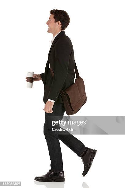 happy businessman with coffee - walking side by side stockfoto's en -beelden