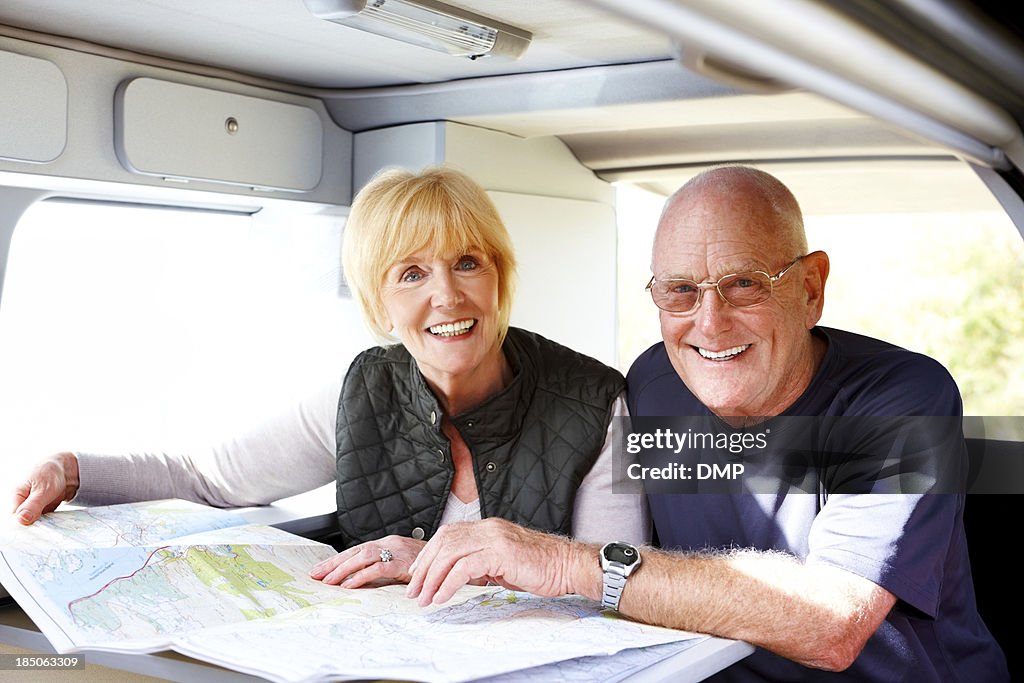 Happy senior couple planning for a roadtrip