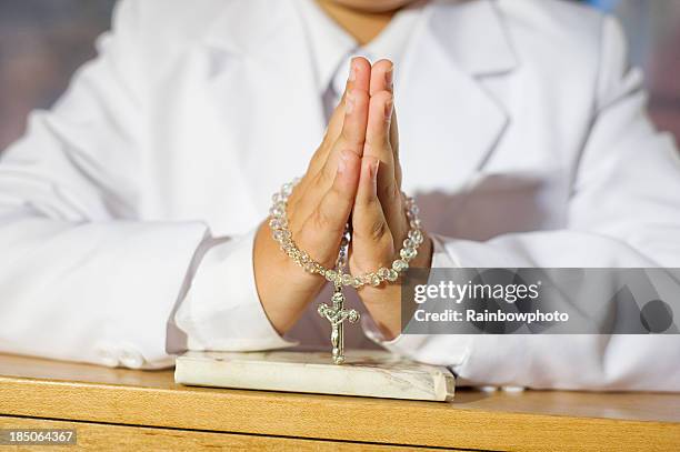 close up of boy praying - heilige communie stockfoto's en -beelden