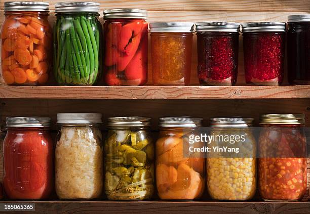 home canning, preserving, pickling food stored on wooden storage shelves - food staple stock pictures, royalty-free photos & images