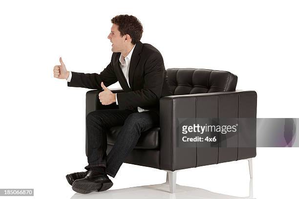 businessman sitting in armchair - armchair isolated stock pictures, royalty-free photos & images