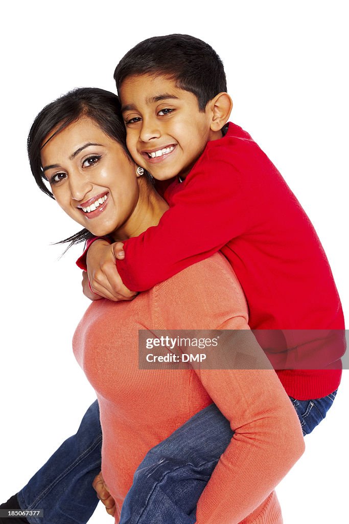 Young woman giving piggyback ride to her son