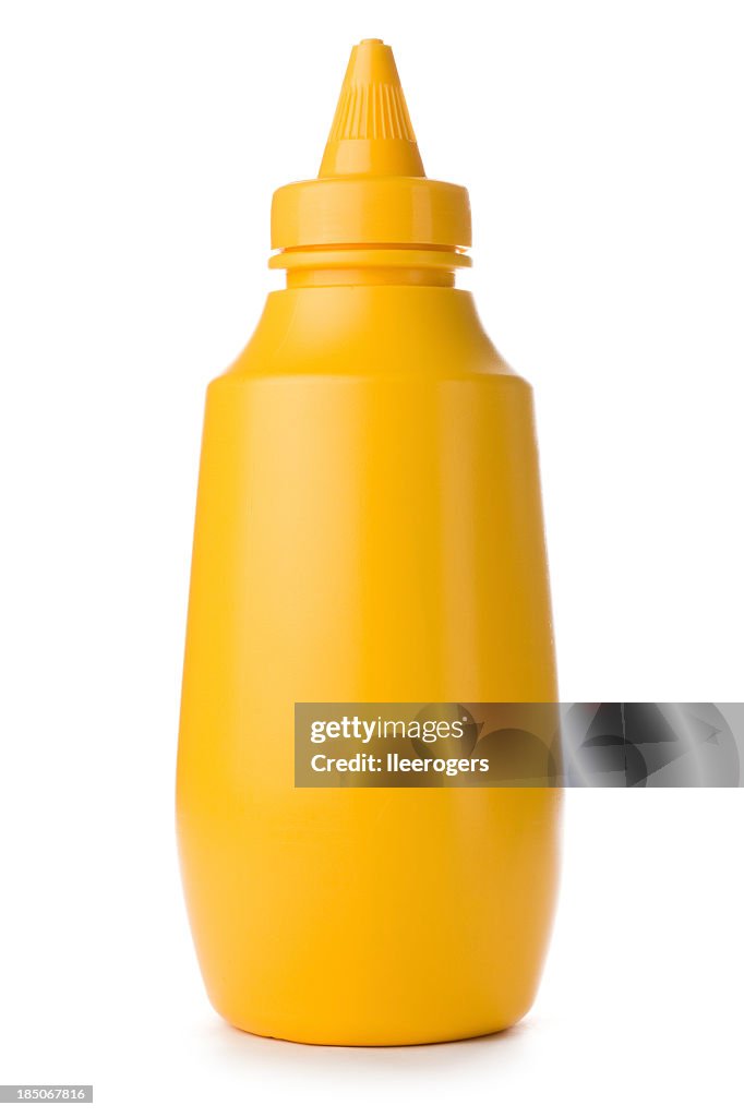 Close-up of yellow mustard bottle on a white background