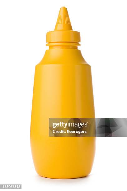 close-up of yellow mustard bottle on a white background - mustard stock pictures, royalty-free photos & images