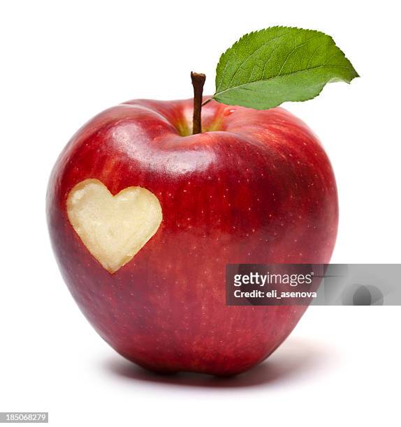 red apple with a heart symbol - apple heart stock pictures, royalty-free photos & images