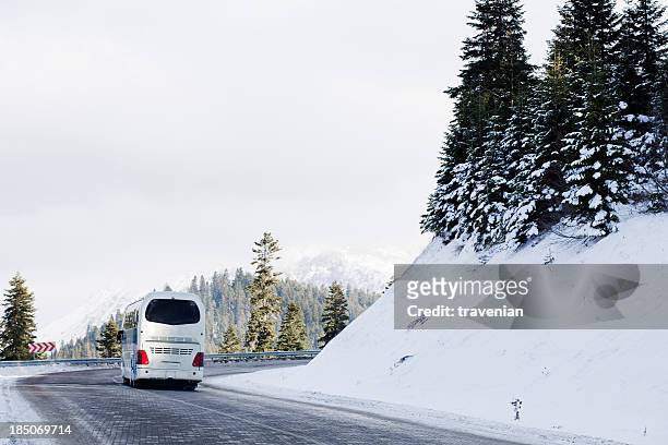 bus on snowy road - bus lane stockfoto's en -beelden