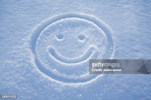 smile. a face drawing in the snow. - face snow stock pictures, royalty-free photos & images