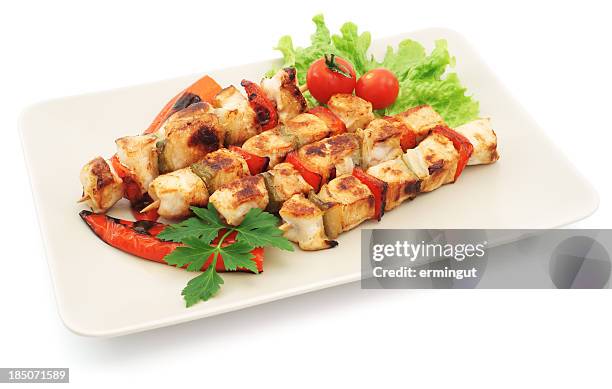 four grilled chicken kabobs with salad on plate - isolated - kebab stock pictures, royalty-free photos & images