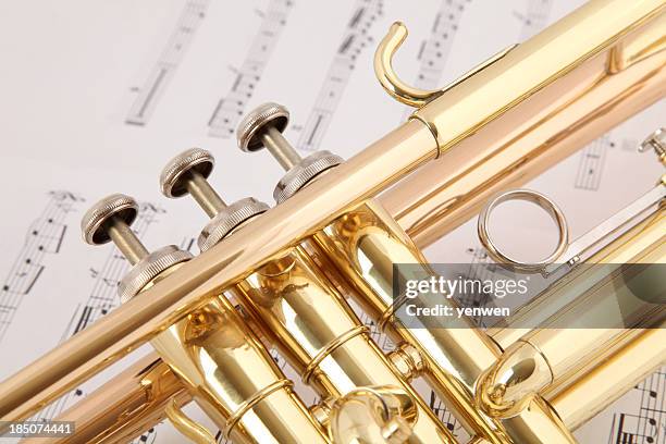 trumpet on music - brass band stock pictures, royalty-free photos & images