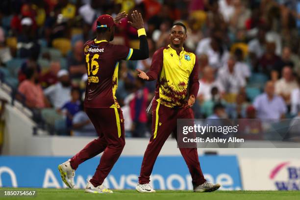 Shimron Hetmyer and Romario Shepherd of West Indies celebrate the wicket of Phil Salt of England during the 1st T20 International between West Indies...