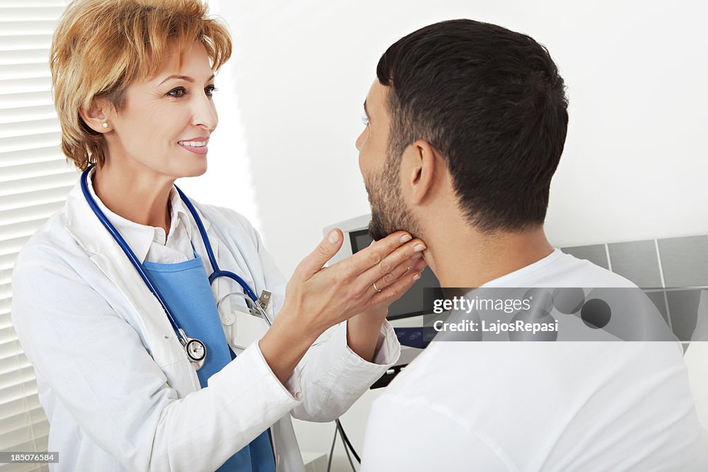 Female doctor examining a young man