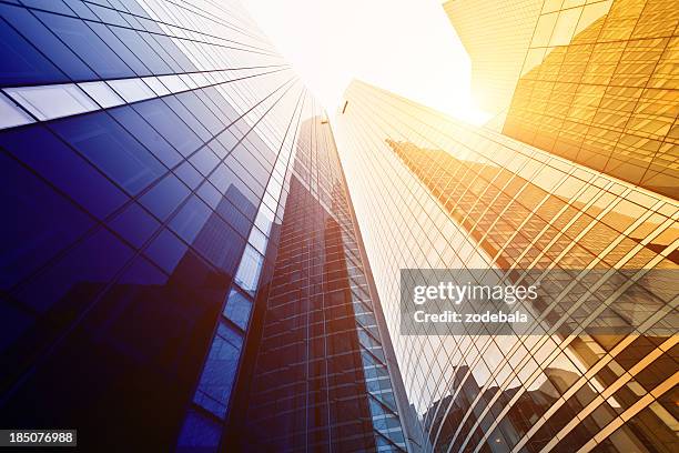 looking up at tall buildings with sun shining down - international centre stock pictures, royalty-free photos & images