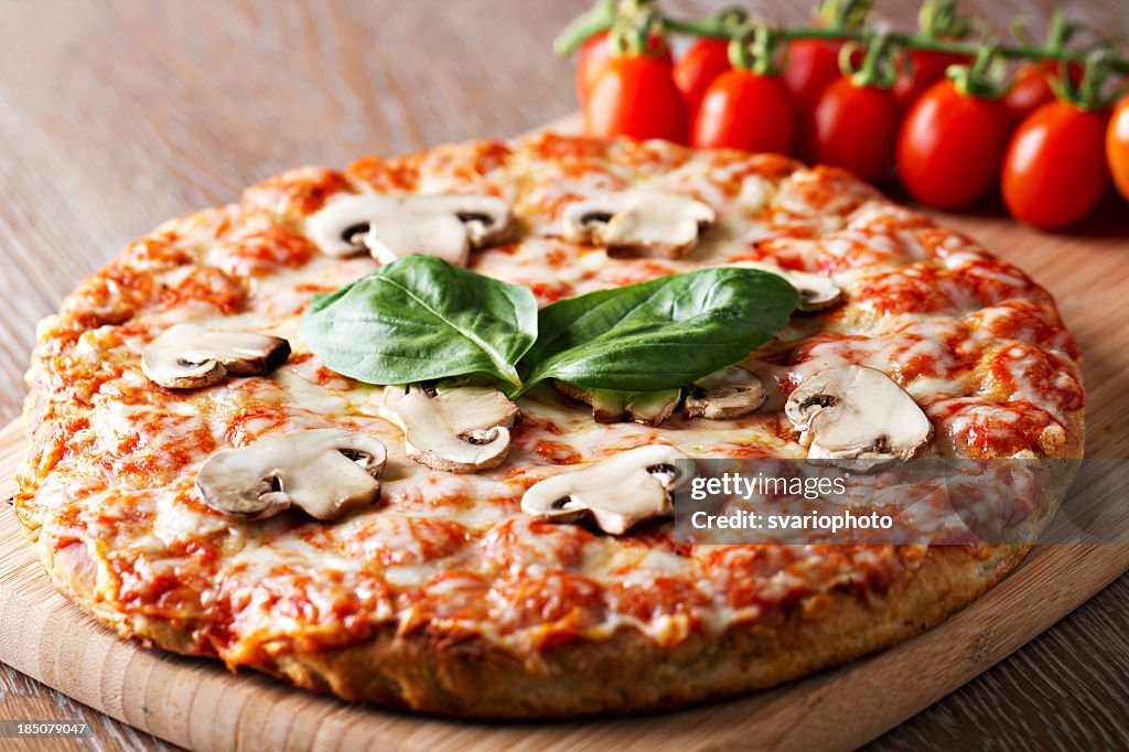 Pizza with mushrooms and basil