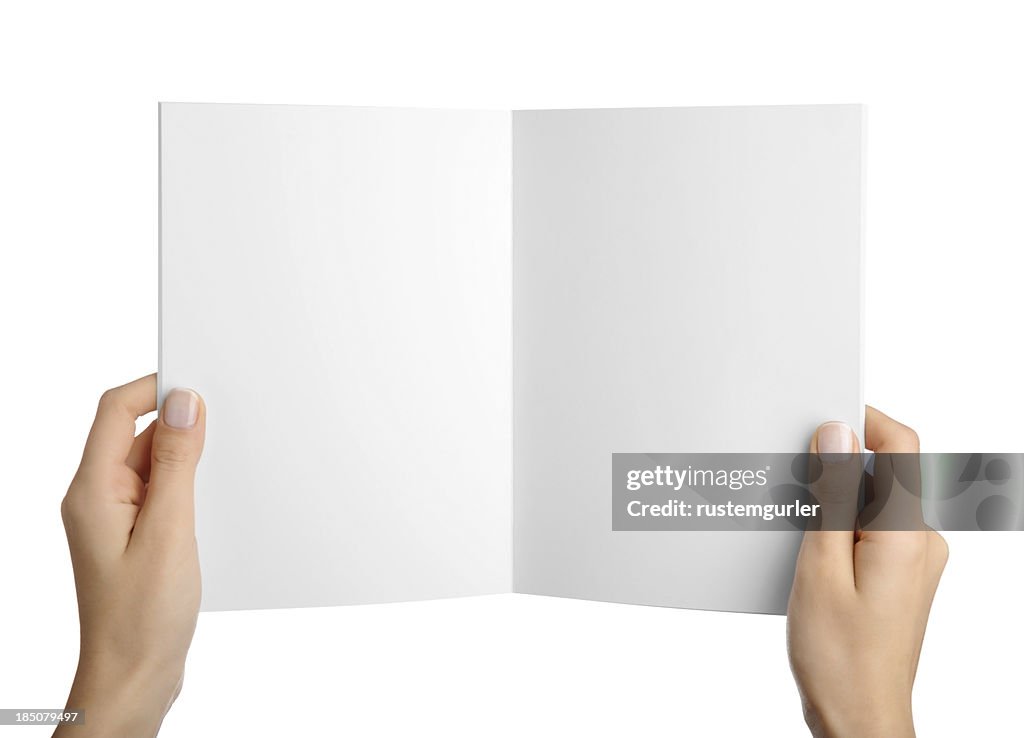 Hands holding blank magazine page
