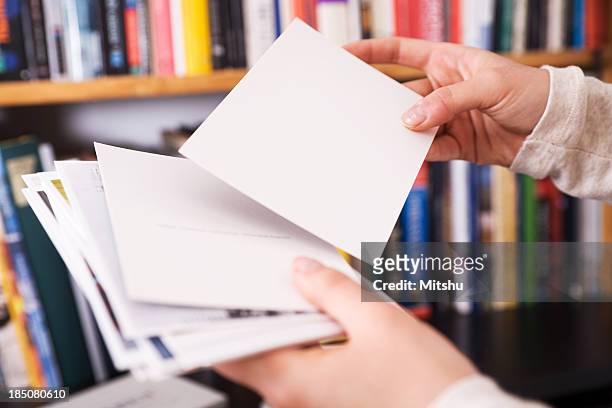femal hands holding postcards - ansichtskaart stockfoto's en -beelden