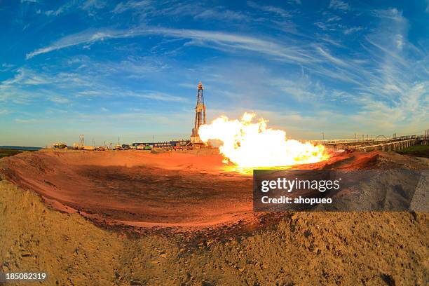 gas flame in front of oil rig (russia) - oil pump stock pictures, royalty-free photos & images