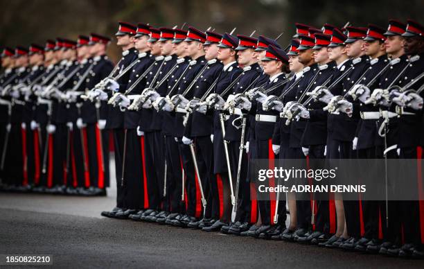 Army officer cadets stand on parade during Commissioning Course No. 231 Sovereign's Parade, at the Royal Military Academy Sandhurst southwest of...