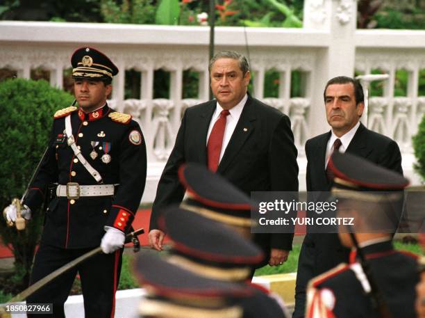 Chilean President Eduardo Frei and Salvadoran President Armando Calderon Sol , along with a military official , pass by an honor guard during a...