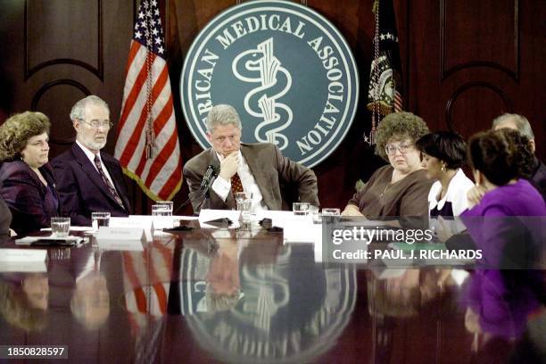 President Bill Clinton listens to first person details of dealing with health care providers during a Patients Bill of Rights round table discussion...