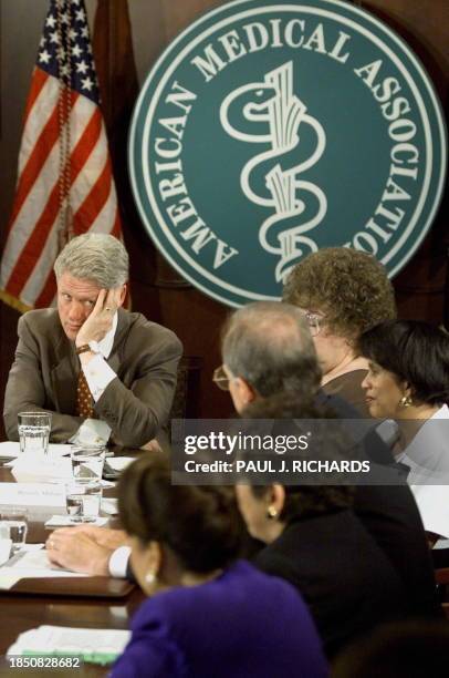 President Bill Clinton listens to shocking and dismal first person details of dealing with health care providers 15 July during a Patients Bill of...