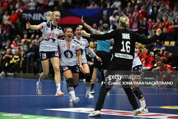 Norway's centre back Henny Ella Reistad celebrates with team mates after scoring her team's winning goal during the semi final match between Denmark...