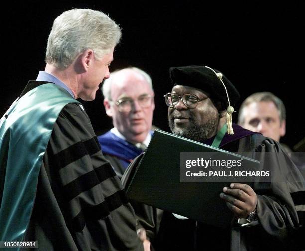 President Bill Clinton is presented an honorary Doctor of Humane Letters by Portland State University President Daniel Bernstine as Provost Michael...