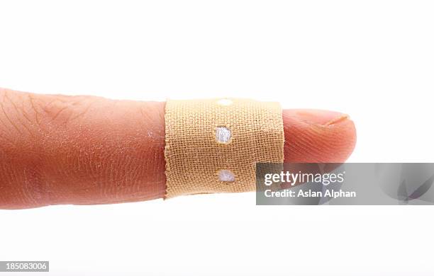 human finger with bandage - thumb bandage stock pictures, royalty-free photos & images