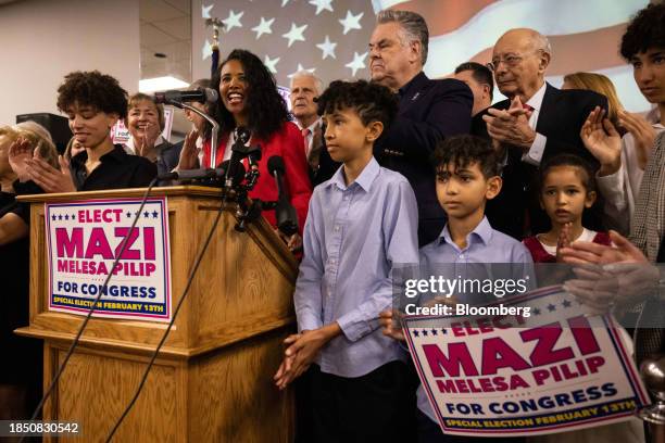 Mazi Melesa Pilip, Nassau County legislator, second left, and former Representative Peter King, top center, during a news conference in Massapequa,...