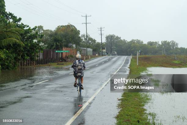 Man cycles along a road in the northern beaches suburb of Holloways Beach after the Tropical Cyclone Jasper. Tropical Cyclone Jasper made landfall...