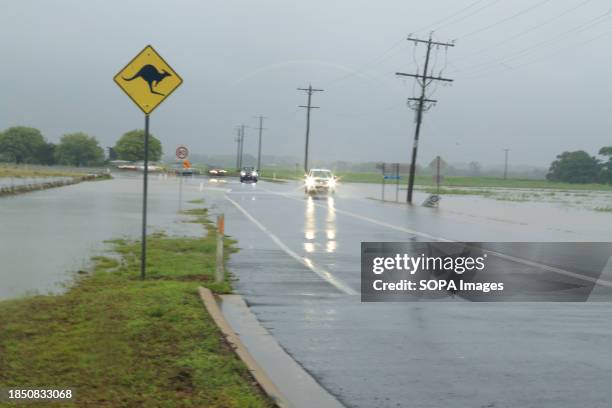 Cars attempt to pass a road in the northern beaches suburb of Holloways Beach in Cairns after the Tropical Cyclone Jasper. Tropical Cyclone Jasper...