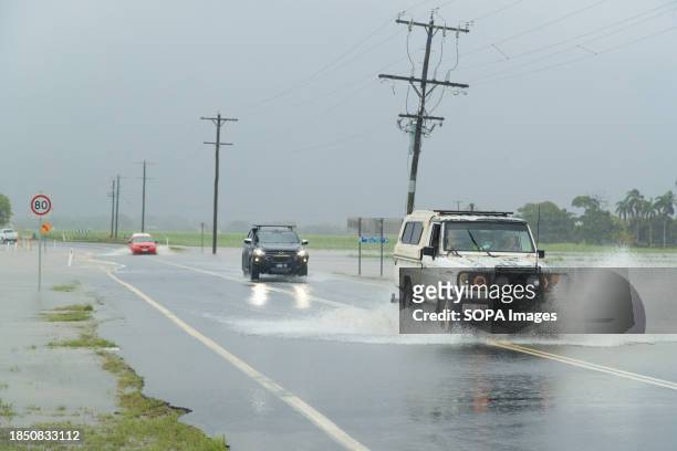 Cars attempt to pass a road in the northern beaches suburb of Holloways Beach in Cairns in the aftermath of Tropical Cyclone Jasper. Tropical Cyclone...