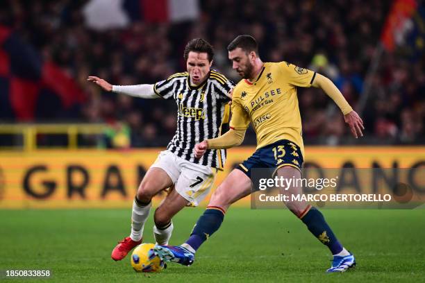 Juventus' Italian forward Federico Chiesa fights for the ball with Genoa's Italian defender Mattia Bani during the Italian Serie A football match...