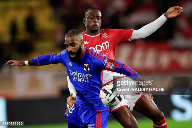 Lyon's French forward Alexandre Lacazette fights for the ball with Monaco's Swiss midfielder Denis Zakaria during the French L1 football match...