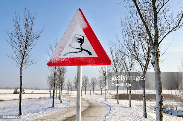 slippery warning - snowy road stock pictures, royalty-free photos & images