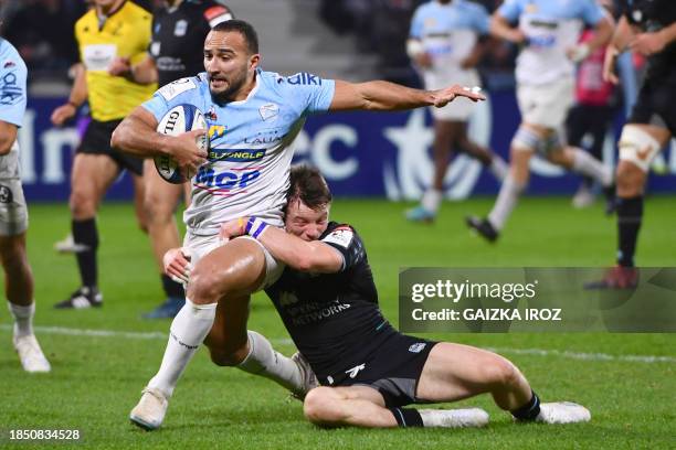 Bayonne's algerian winger Nadir Megdoud is tackled during the European Champions Cup second round day 2 group C Rugby Union match between Aviron...