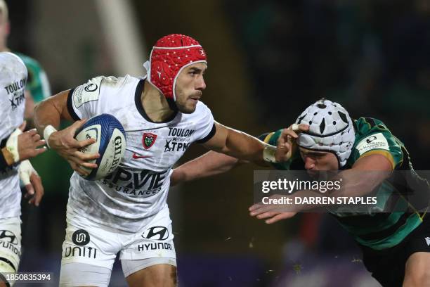 Toulon's French wing Gabin Villiere hands-off Northampton Saints' English hooker Curtis Langdon during the European Rugby Champions Cup Pool 3 rugby...