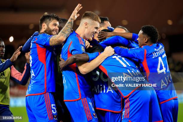 Lyon's Brazilian forward Jeffinho celebrates with teammates after scoring the first goal for his team during the French L1 football match between...